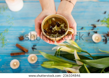Holding cup of herbal tea in spa salon
