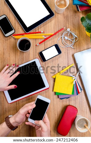 Working or studying with digital gadgets and different colorful stuff and coffee on the wooden table. Top view