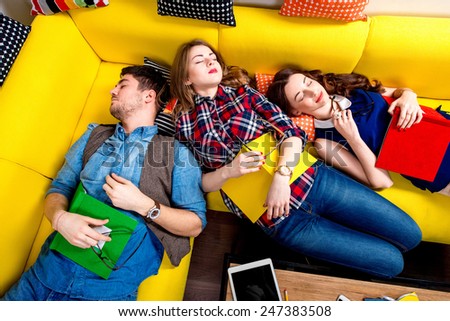 Sleeping and tired young students felt sleep after work on the yellow couch