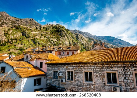 Ancient buildings in Kotor city with mountain on background in Montenegro