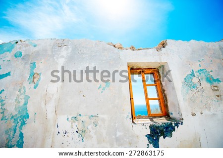 Old window in abandoned house with beautiful view at sea