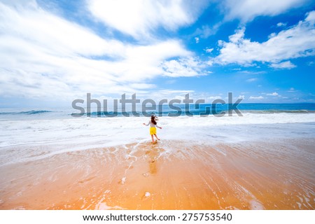 Young woman running on the beach. General plan with space for your text