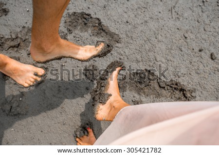Couple showing feet smeared in the mud