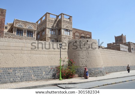 Sana\'a, Yemen, March, 18, 2014. Yemeni scene: People walking near the ancient fortress wall of old town Sana\'a