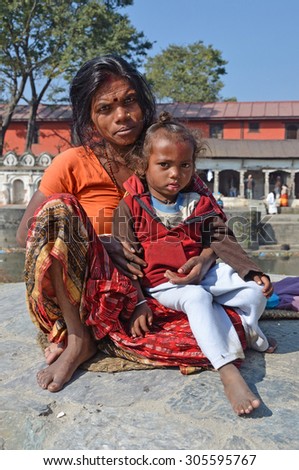 Kathmandu, Nepal,,October, 27, 2012, Nepali  Scene: the poor woman with a child begging in ancient Pashupatinath complex on the bank of the sacred Bagmati river.
