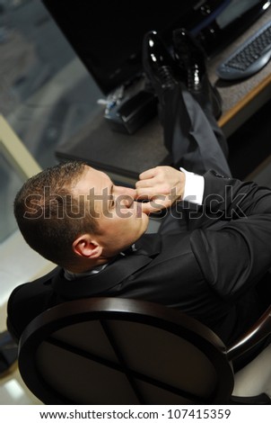 Yang businessman relaxing in the hotel suite.