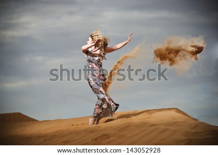 Yang and beautiful European woman having fun in yellow desert.