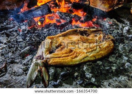 Sea fish,cooked on open fire.