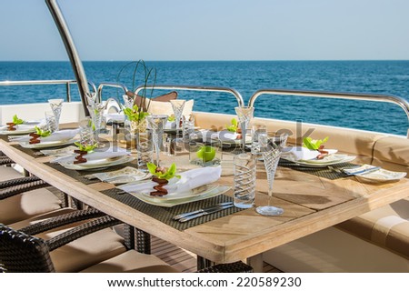 Dinning table on the upper deck in luxurious yacht.