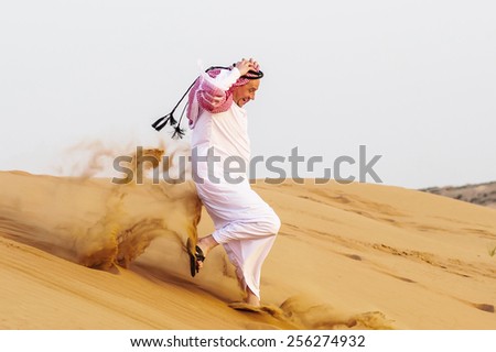 Portrait of Middle Eastern arab man run in desert..
