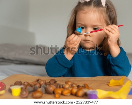 Similar – Image, Stock Photo Child playing with acorns