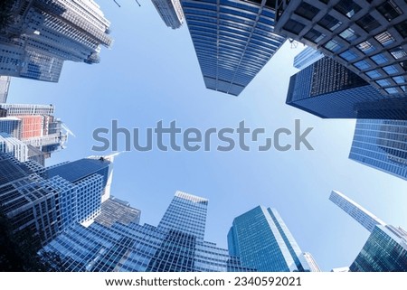 Similar – Image, Stock Photo Bottom view of skyscraper building against gray sky and clouds. Looking up view in apartment building in the city. Real estate and corporate construction. Multi-storey residential building. Condo.