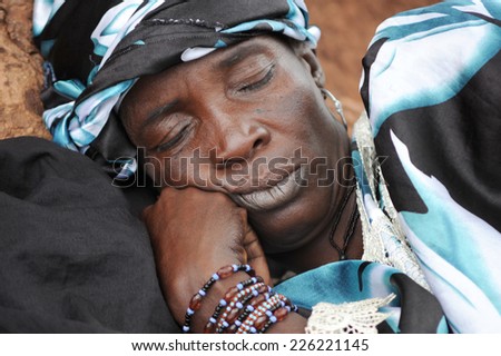 MOPTI, MALI, AFRICA - AUGUST, 26, 2011 African woman sleeping after a day of work in the market of Mopti