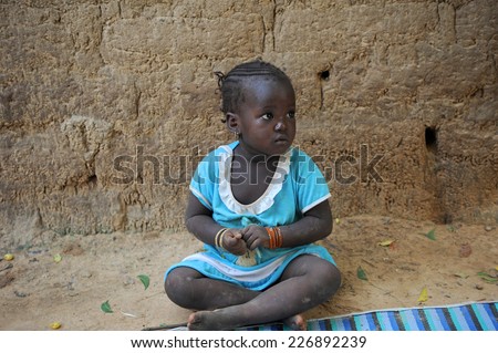 BANDIAGARA, MALI, AFRICA - AUGUST, 28, 2011 Single girl looking for friends to play