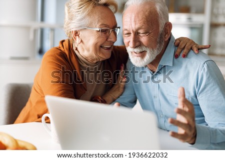Happy  mature couple using  laptop at home Сток-фото © 
