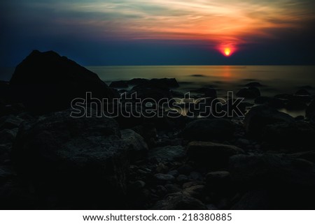 The sun is settning in the andaman sea outside the idyllic island Koh Chang in Thailand