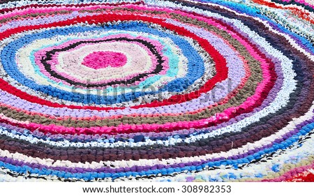 Round rug knitted from strips of fabric.
