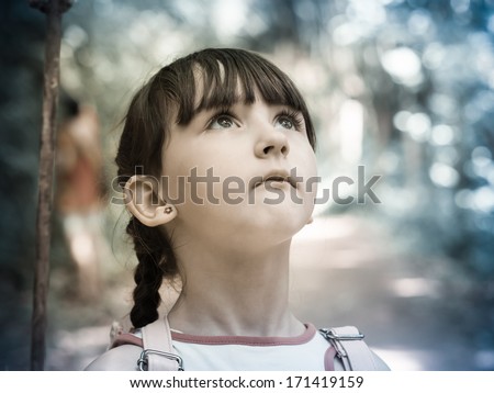 Scared child girl walking at the wild jungle