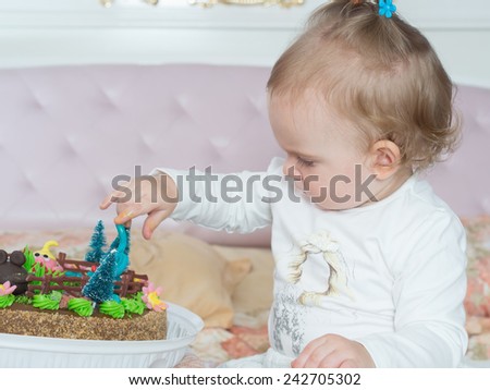 Small caucasian child on happy birthday with cake at home