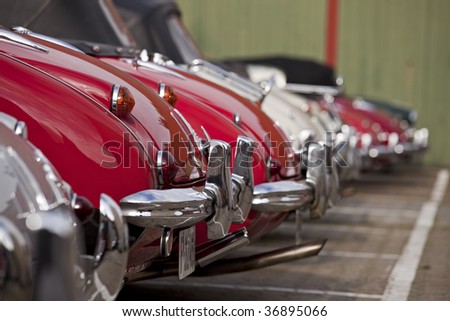 row of bumpers of classical cars