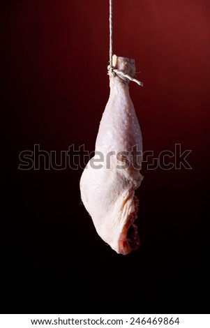 hanging chicken leg on red