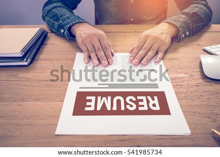 Businessman or job seeker review his resume on his desk before send to finding a new job.