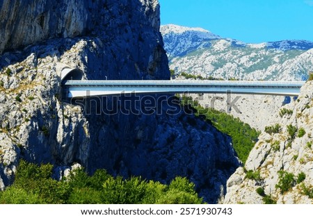 Similar – Image, Stock Photo Old ancient bridge above small river in mountain valley