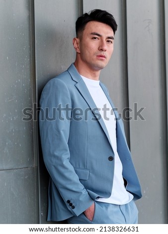 Similar – Image, Stock Photo Handsome Asian man leaning on building