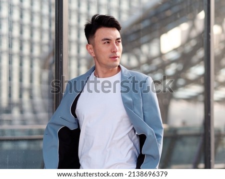 Similar – Image, Stock Photo Confident Asian man walking along city street