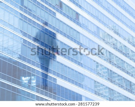 motion blur business people with office window building in background