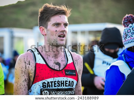 EDINBURGH, SCOTLAND, UK - January 10, 2015 - elite athlete exhausted after the Great Edinburgh Cross Country Run. This Men\'s Invitational 4k race was won by last year\'s champion Garrett Heath of USA.