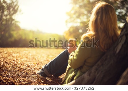 Similar – Image, Stock Photo Anonymous woman with disposable cup of coffee sitting on street bench