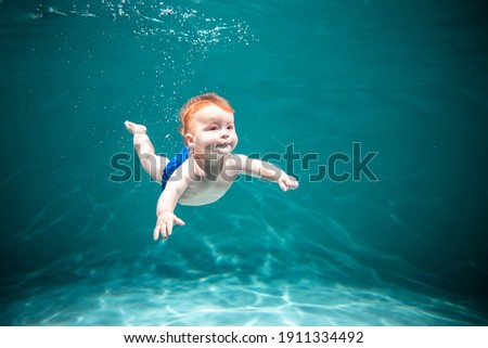 Similar – Image, Stock Photo Funny boy swimming underwater looking at camera