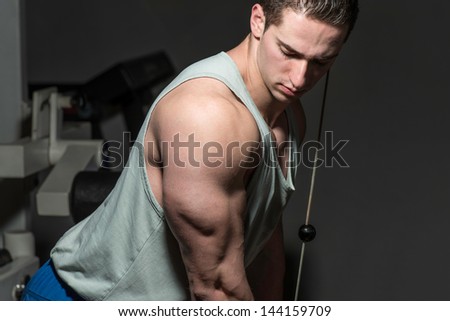 young male bodybuilder doing heavy weight exercise