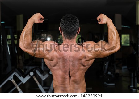 bodybuilder showing his back double biceps