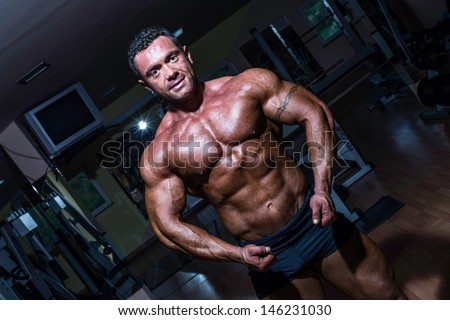muscular bodybuilder showing his upper body