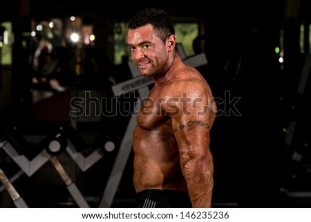 male body builder showing his side triceps