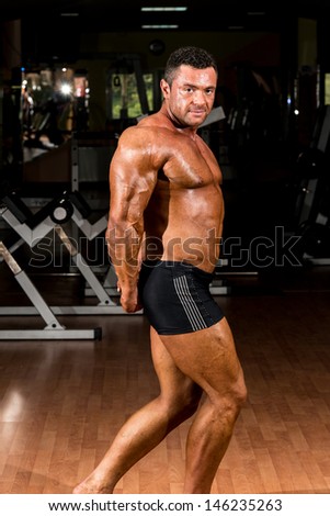 sexy body builder showing his side triceps