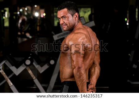 muscular body builder showing his side triceps