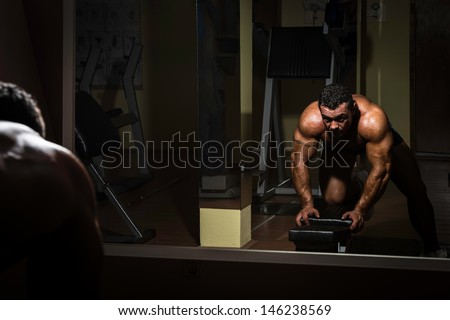body builder doing heavy weight exercise for back