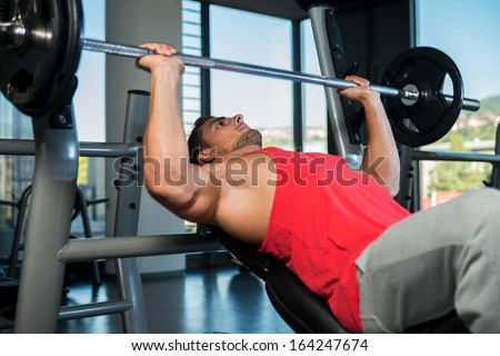 Bench Press Workout. Young Men In Gym Exercising On The Bench Press
