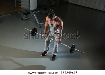 Bent Over Barbell Row. Man Doing Heavy Weight Exercise For Back