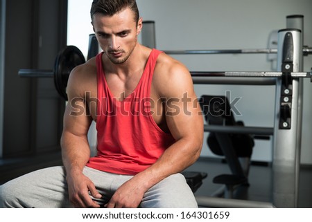 Rest On The Bench. Portrait Of A Young Muscular Sporty Fit Caucasian Man Resting At The Bench