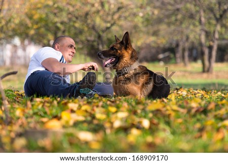 Man Holding Dog German Shepherd