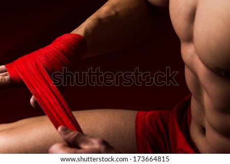 Boxer Getting Ready - Muscled Boxer Wearing Red Strap On Wrist