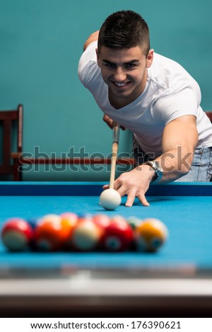 Man Playing Pool - Lining To Hit Ball On Pool Table