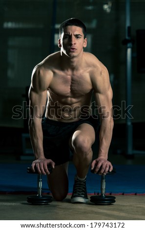 Be Strong - Young Muscular Men Kneeling On The Floor With A Pair Of Dumbbells