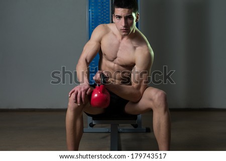 Young Man Exercise With Kettle Bell Biceps