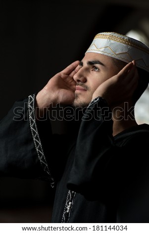 Young Muslim Guy Praying - Man Making Traditional Prayer To God While Wearing A Traditional Cap Dishdasha