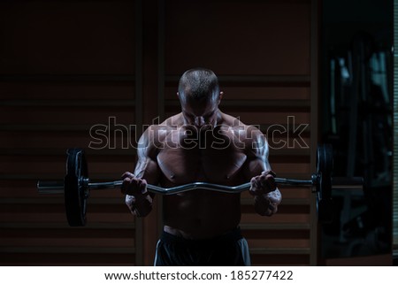 Dark Warrior - Muscular Man Doing Heavy Weight Exercise For Biceps